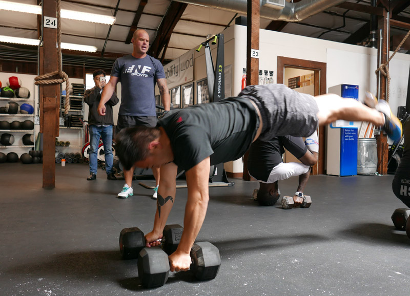 Kelly Starrett leading a workout session with Toan Lam